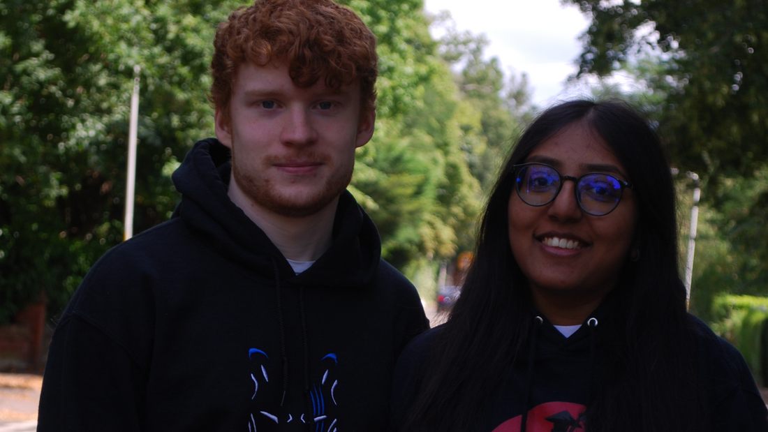 Two models smiling wearing Shujinko Anime Merch.