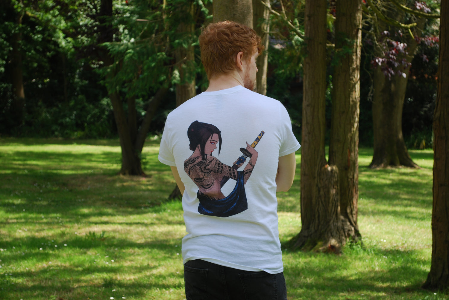 Man modelling white t shirt with woman holding a katana, back print.