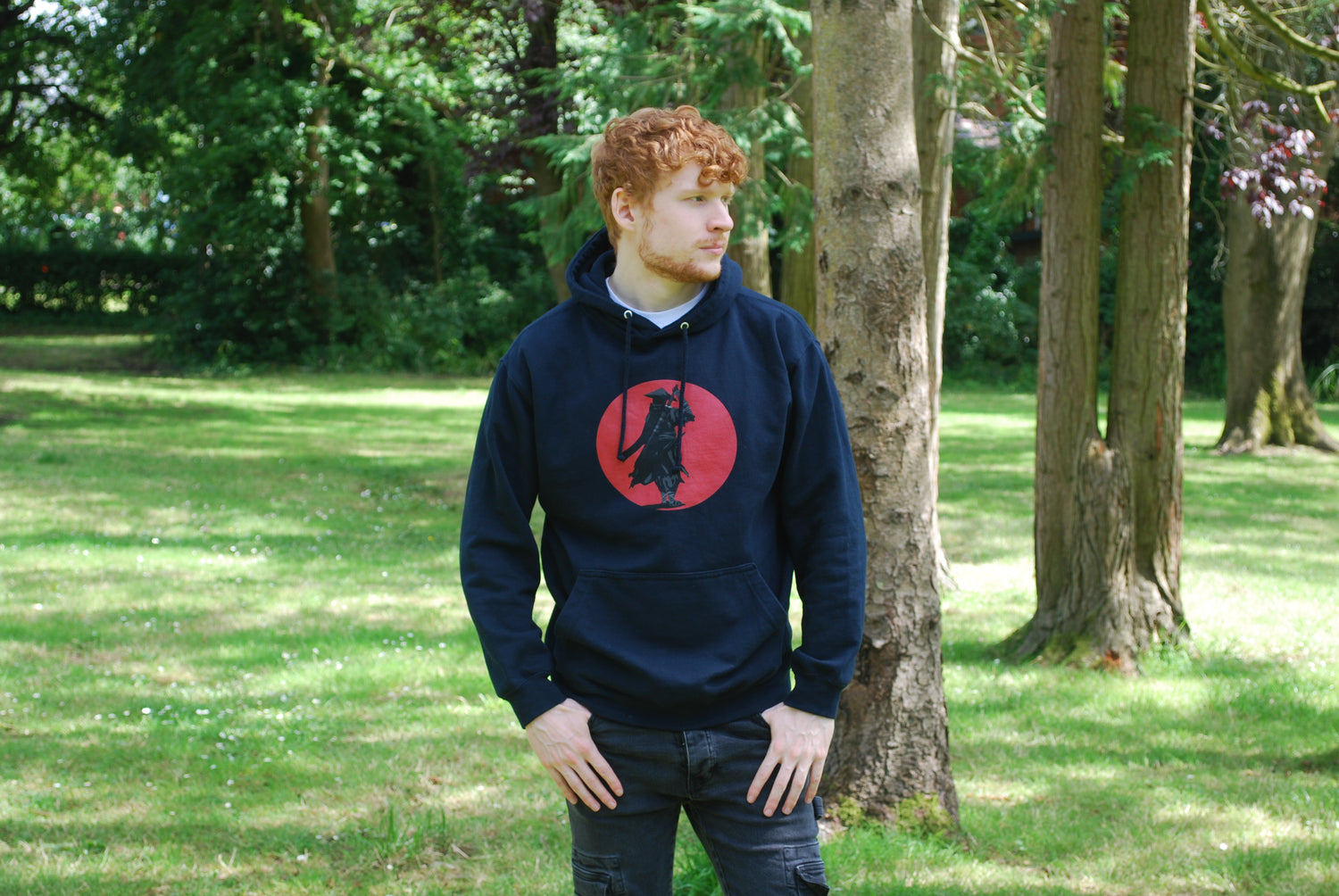 Man modelling navy samurai hoodie with front print.