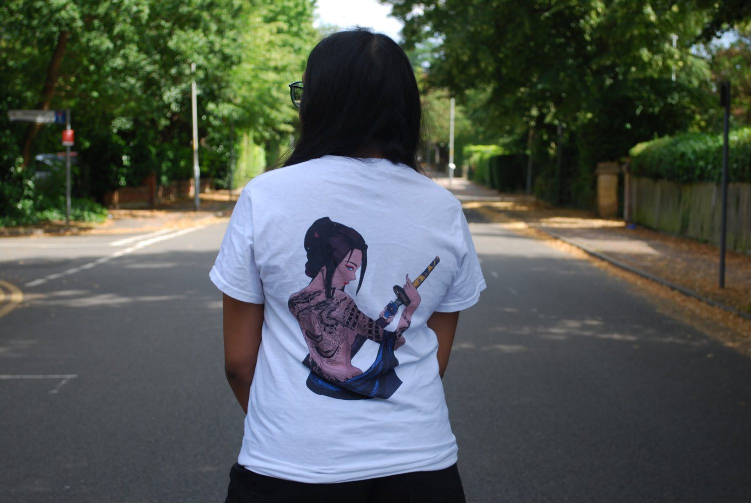 Female model wearing a white tee with the blade goddess print.